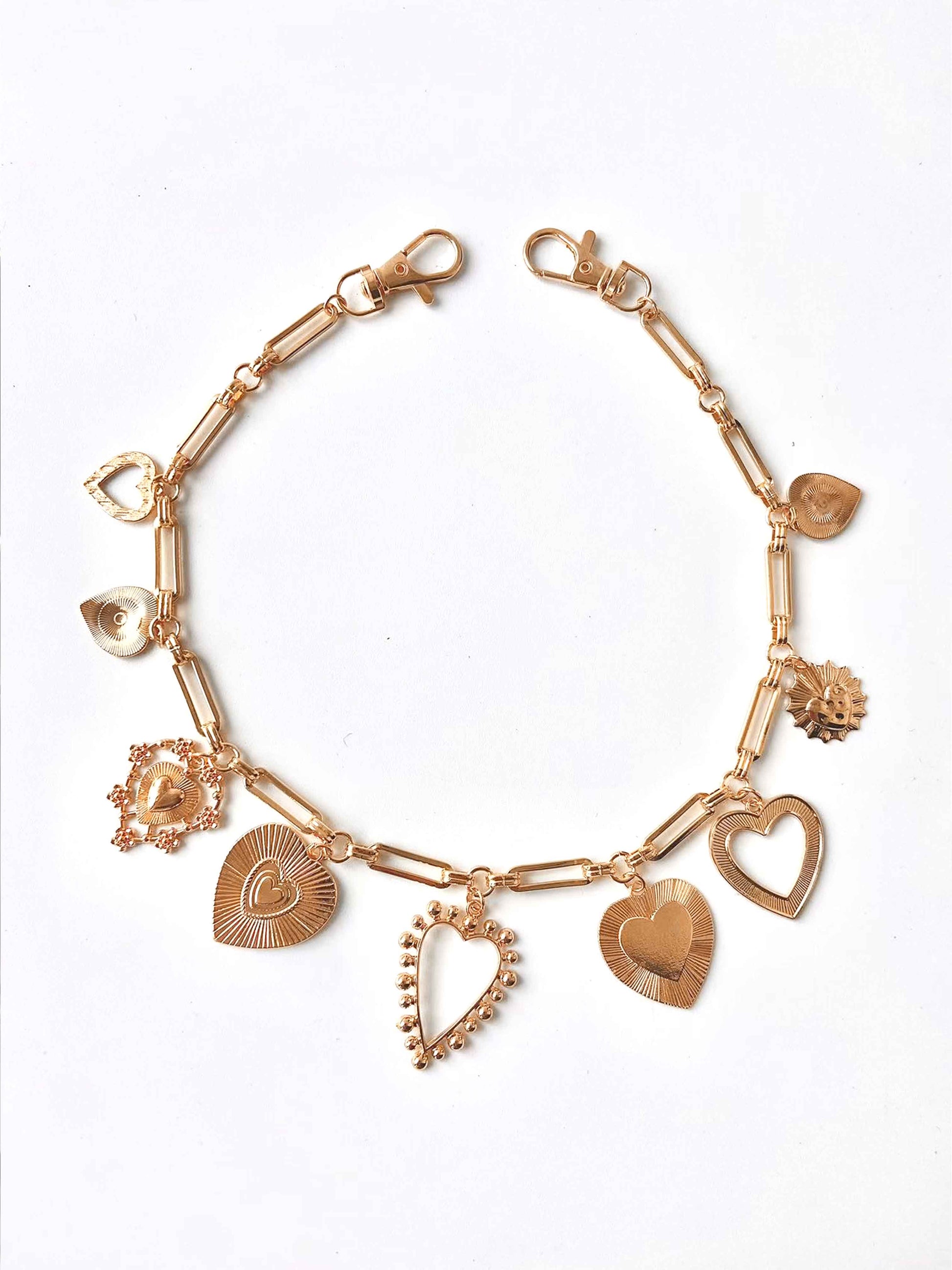 Golden heart pendant chain, various heart shapes, fine details.