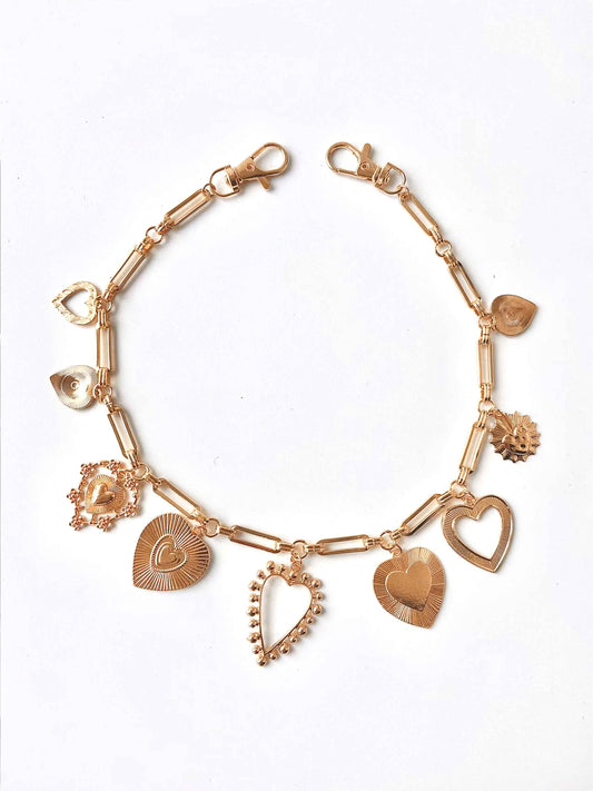 Golden heart pendant chain, various heart shapes, fine details.