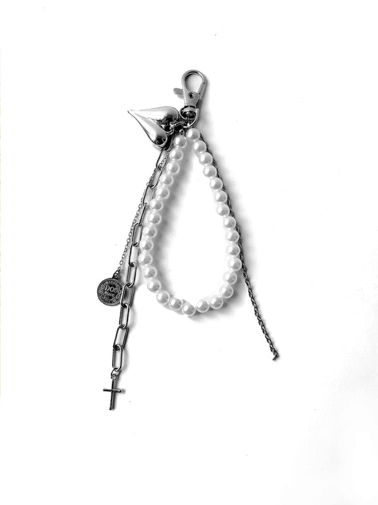 Edgy charm close-up, faux pearl strand with heart metal piece, DOS coin and cross pendant.