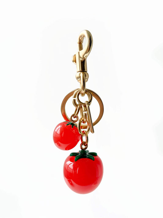 Exquisite double tomato metal bag charm keychain with fine details.