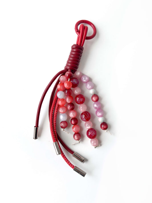 Pink - red beaded leather tassel charm, with exquisite details and unique design.