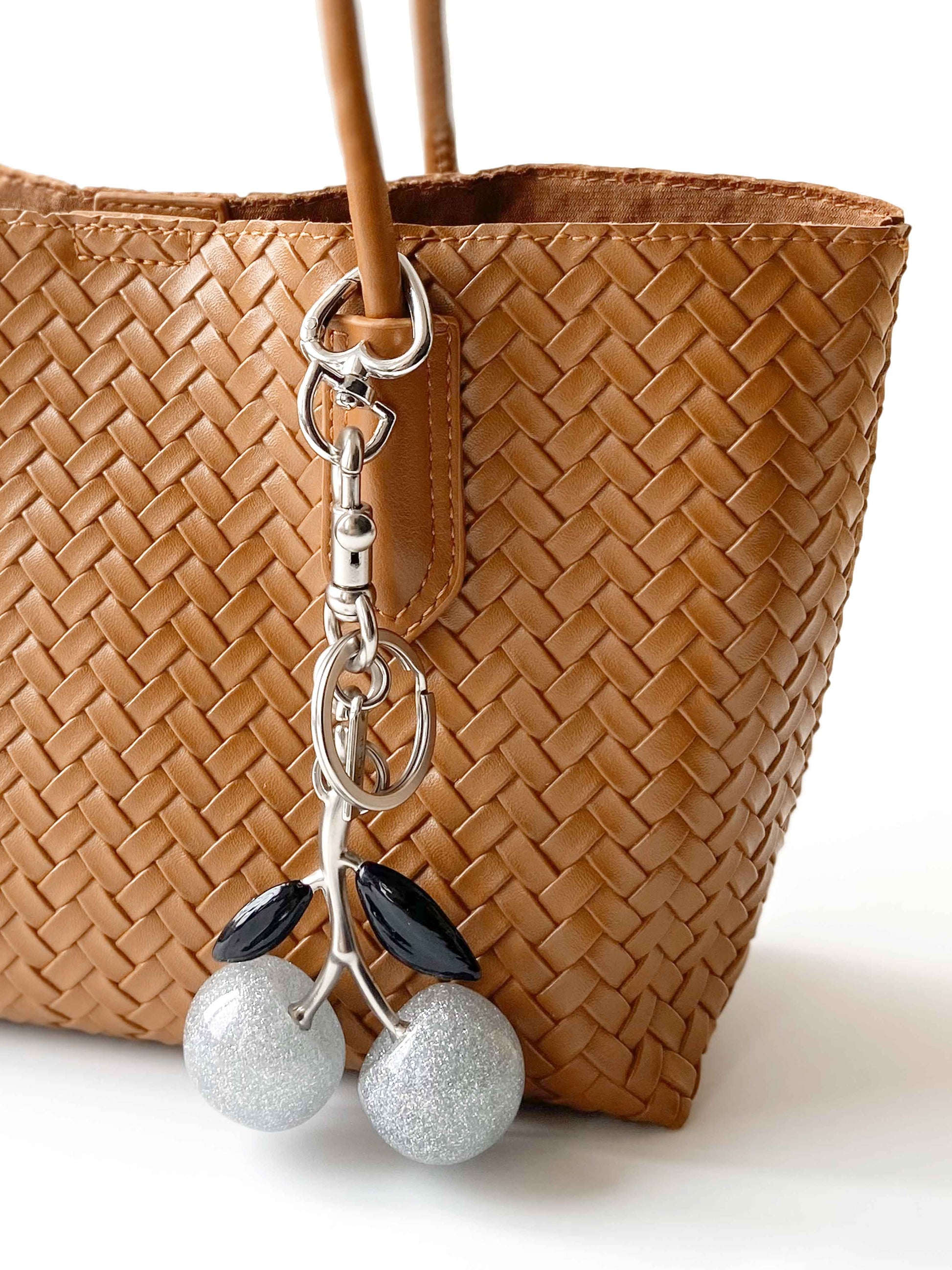 Close-up of silver glitter cherry charm - Detailed weaving texture and metal chain, exquisite craftsmanship
