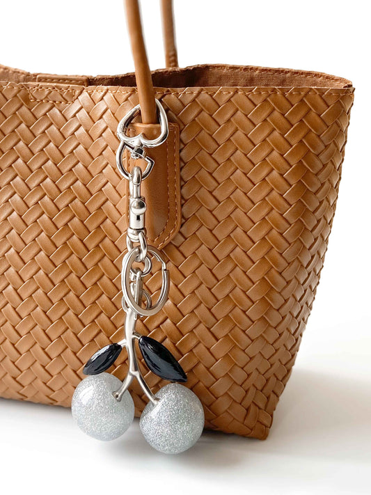 Close-up of silver glitter cherry charm - Detailed weaving texture and metal chain, exquisite craftsmanship