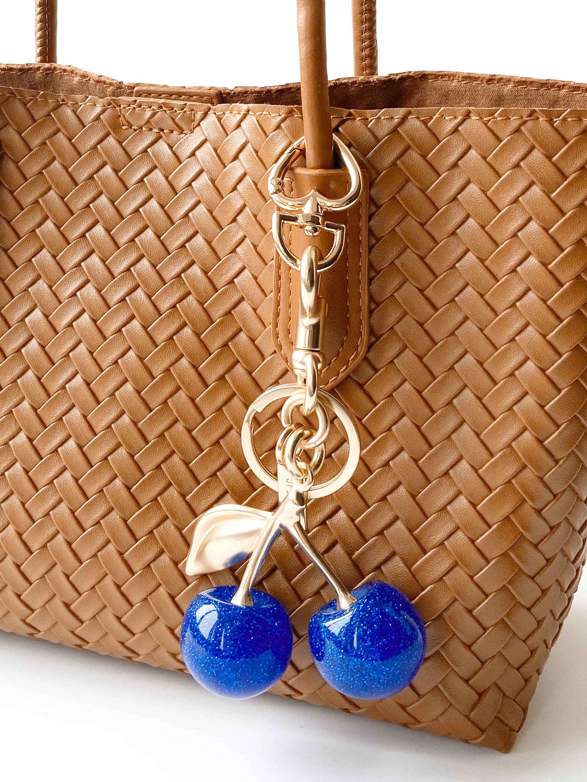 Brown Woven Handbag with Blue Cherry Charm, Stylish and Cute.