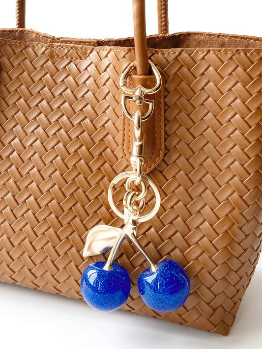 Brown Woven Handbag with Blue Cherry Charm, Stylish and Cute.